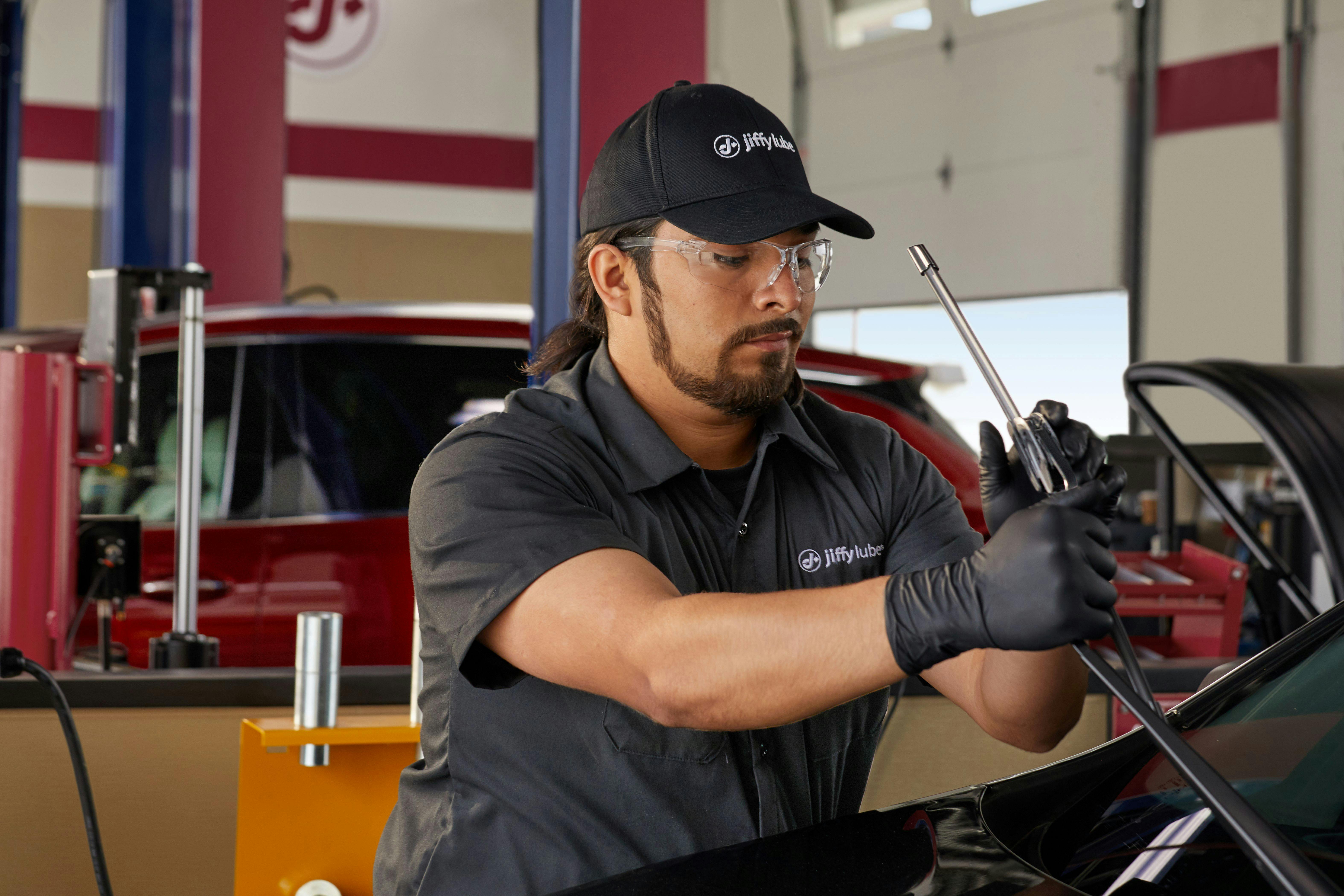 Jiffy Lube technician replacing wiper blades